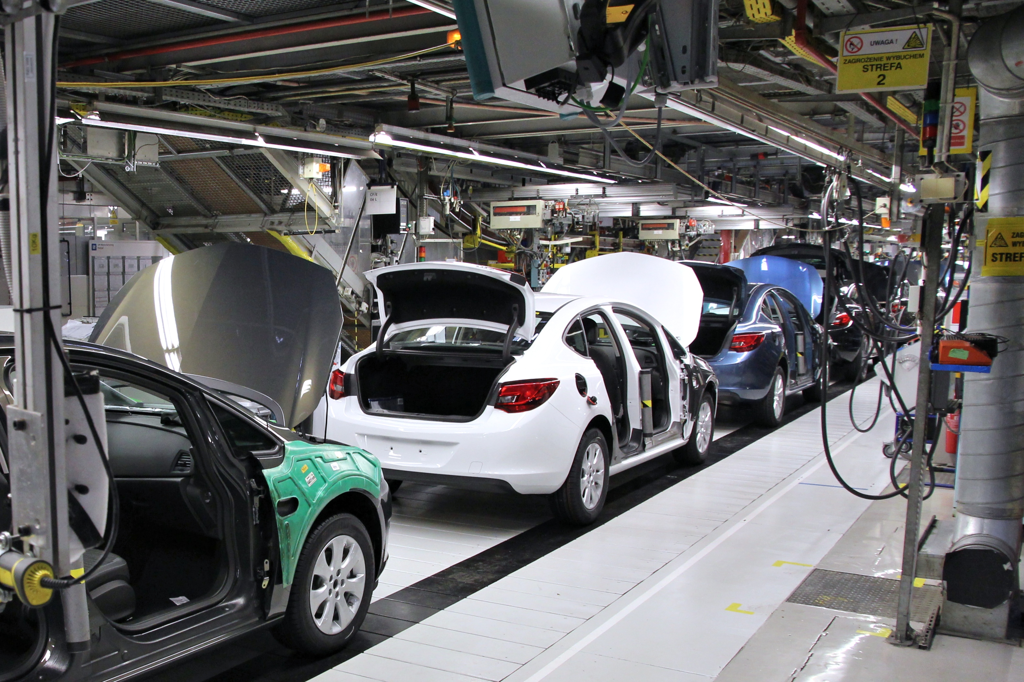Robotic arms on an automotive assembly line