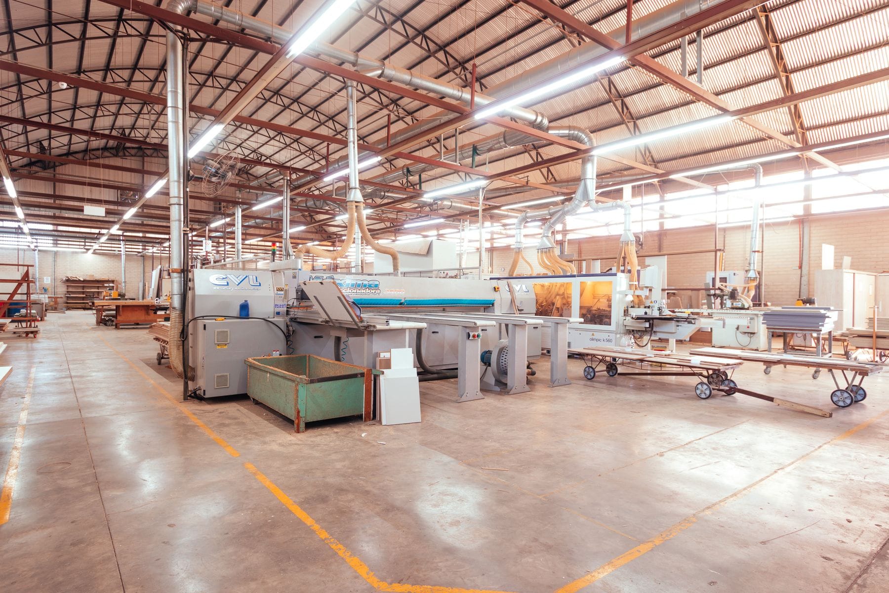 Organized factory floor with machinery lined up under bright lighting