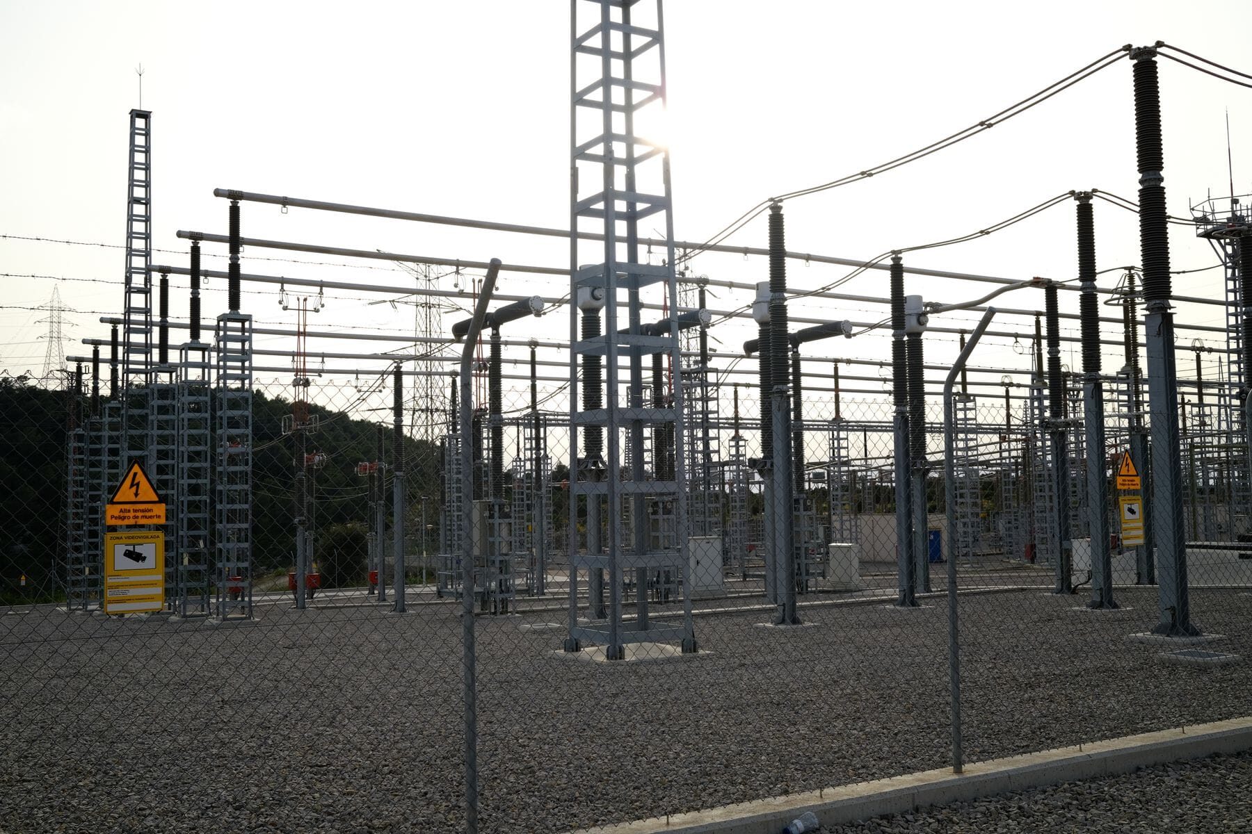 Outdoor electrical substation with high voltage equipment serving an industrial site