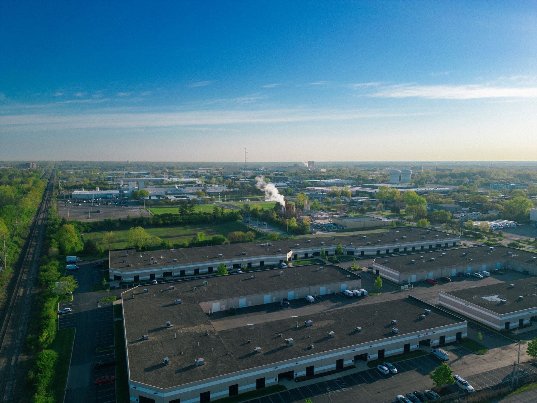 Aerial view of an industrial district with warehouse roofs and access roads