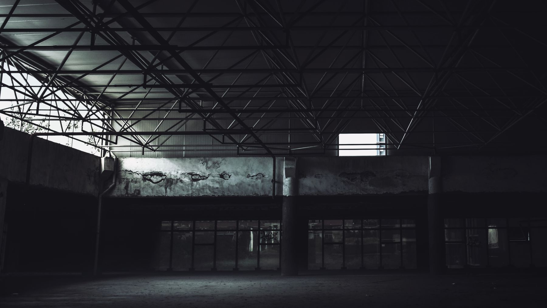 Dark empty industrial building interior with steel beams