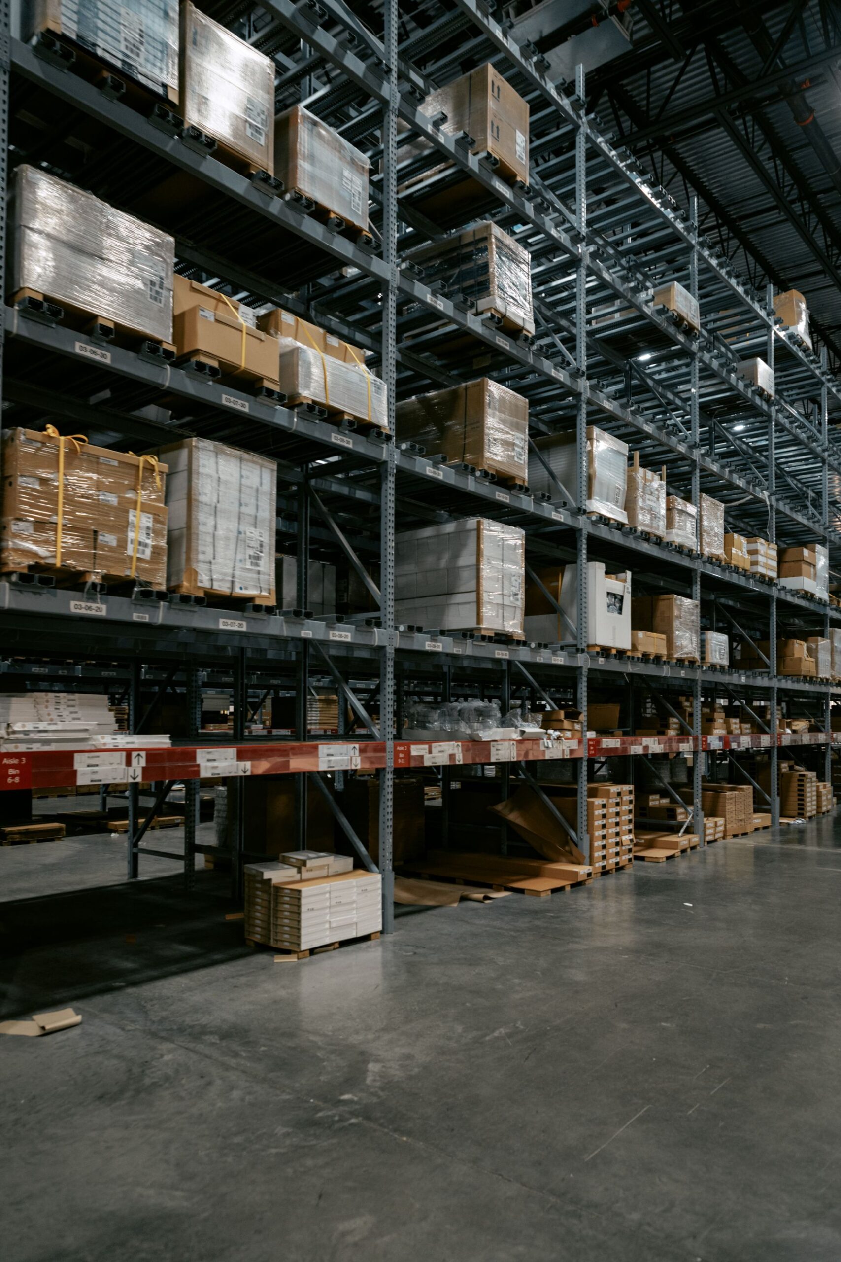 Warehouse aisle lined with pallet racking stacked with boxed goods