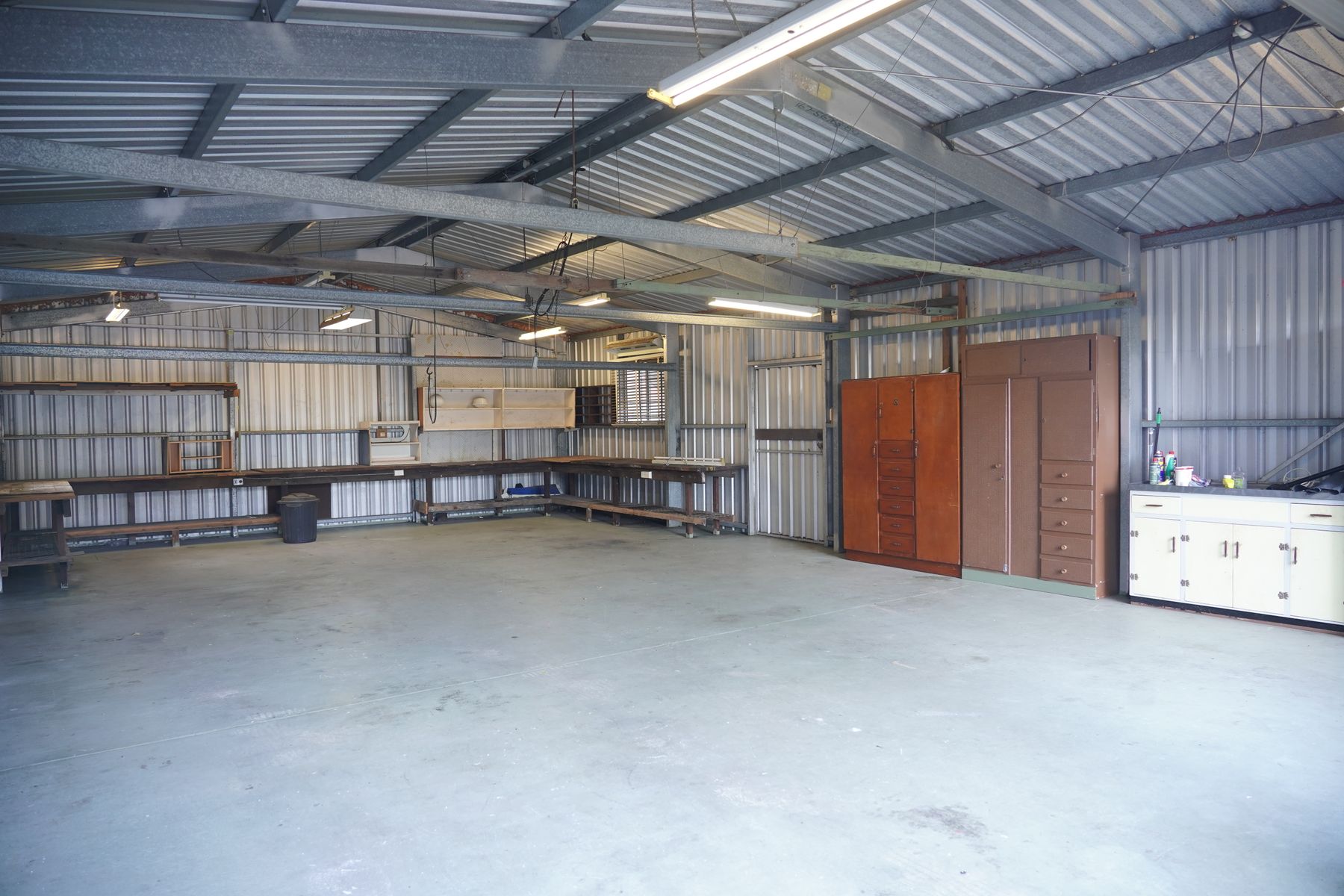 Empty industrial workshop with bare steel workbenches