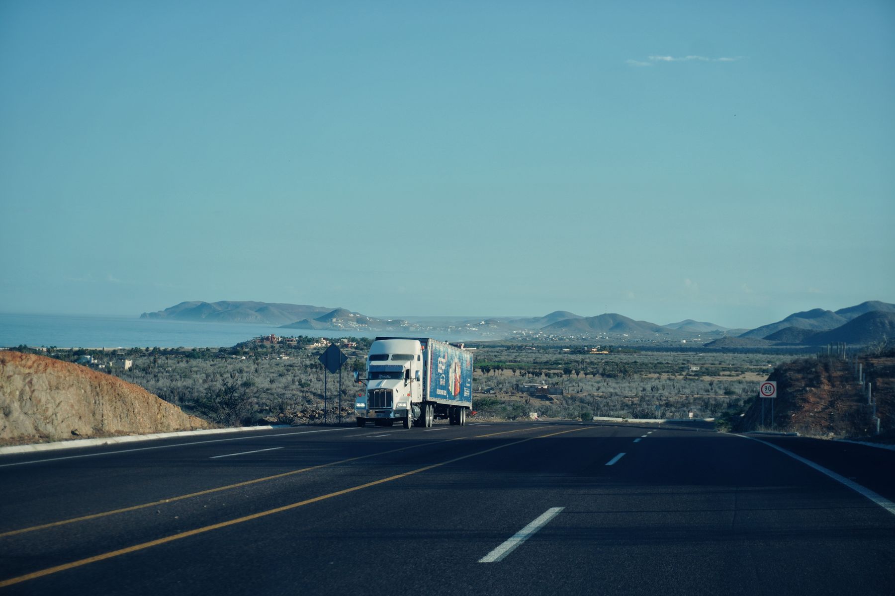 Loaded freight truck travelling along a coastal highway